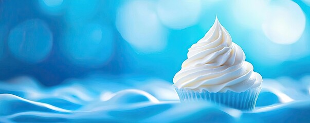 Delicious Creamy Cupcake on a Soft Blue Background with Bokeh Effect