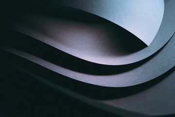 Abstract close-up of layered paper curves creating dynamic shadows and depth in design.