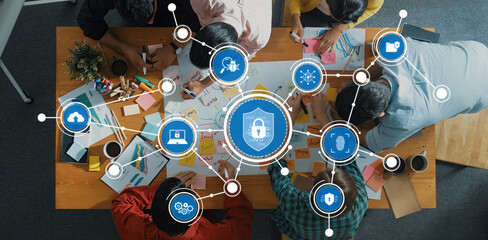 Collaborative Teamwork in Cybersecurity Planning with Digital Security Icons and Creative Workspace Overhead View. Amity