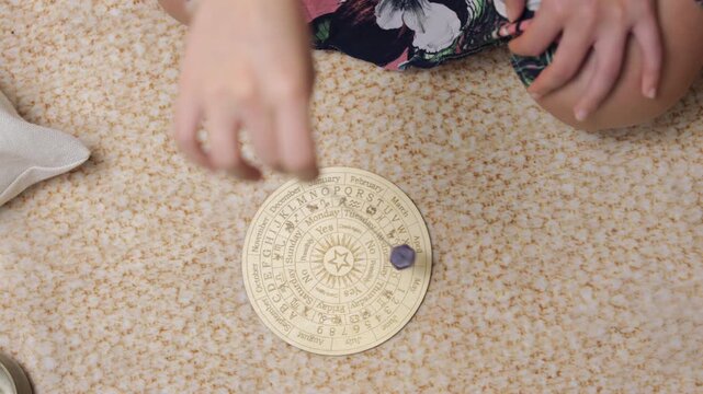 Pendulum dowsing on a chart, seeking answers with calm focus