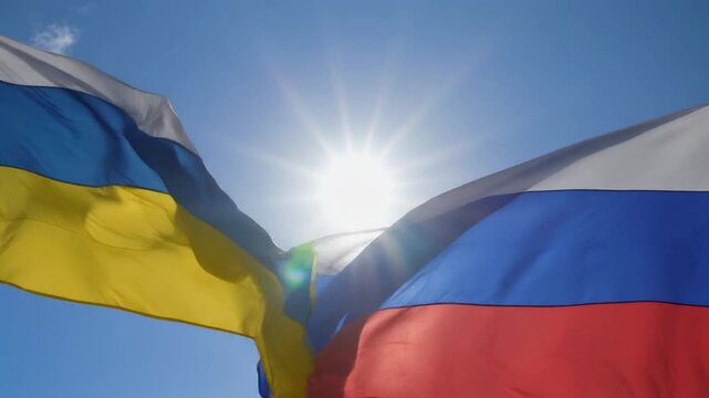 Ukrainian and Russian Flags Fluttering Together in Sunlit Sky