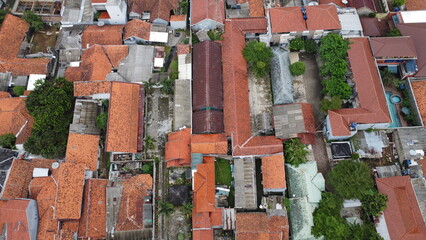 Aerial view of residential area with orange rooftops and lush greenery