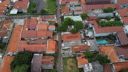 Aerial View of Residential Neighborhood with Orange Roofs and Lush Green Trees