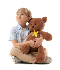 Cute boy with toy bear and yellow ribbon sitting on white background. Childhood cancer awareness...