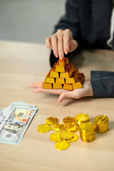 Adult hands arranging gold bars with dollar bills investment strategy wealth management financial planning business success assets security