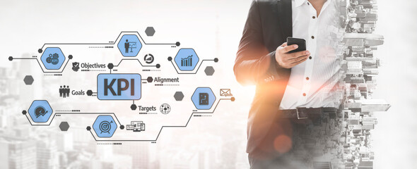 A businessman uses a mobile phone to analyze key performance indicators, connecting strategy and objectives in a vibrant, modern corporate setting. Tessel