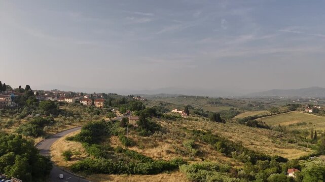 Aerial view of Impruneta near Florence, Italy, featuring winding roads, historic buildings, and scenic Tuscan landscape.