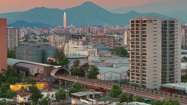 Aerial sunset cityscape of Santiago de Chile, urban landscape with Metro rail in motion