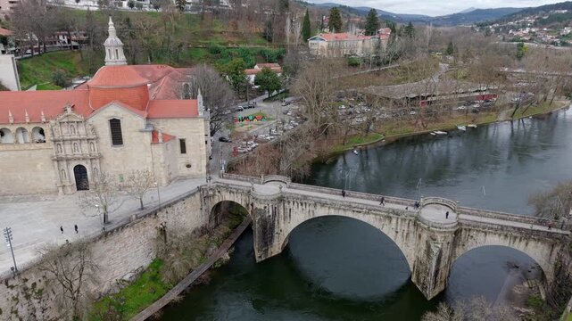 Sao Goncalo catholic church and Convent located by famous stone bridge St Goncalo over Tamega river, Amarante, Drone shot
