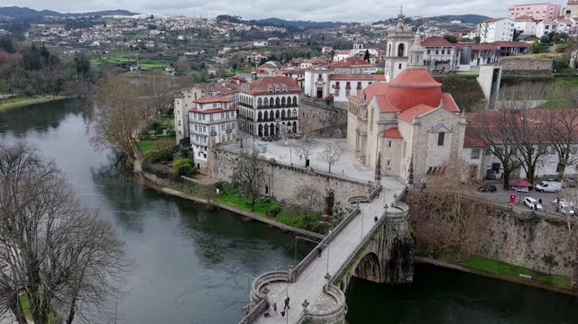 Historic St Goncalo stone bridge over Tamega River connecting Sao Goncalo catholic church, Amarante, Drone shot