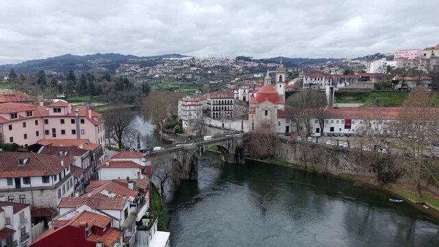Amarante city on the bank of the River Tamega, Igreja de S&atilde;o Gon&ccedil;alo catholic church under cloudy sky, Drone shot