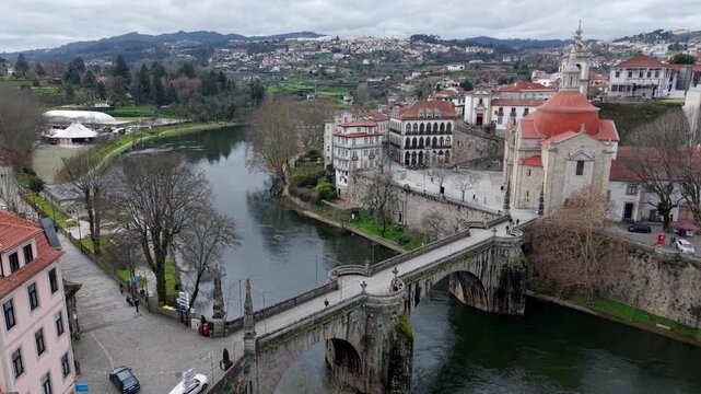Historic St Goncalo stone bridge over Tamega River connecting Sao Goncalo catholic church area, Amarante city, Drone shot