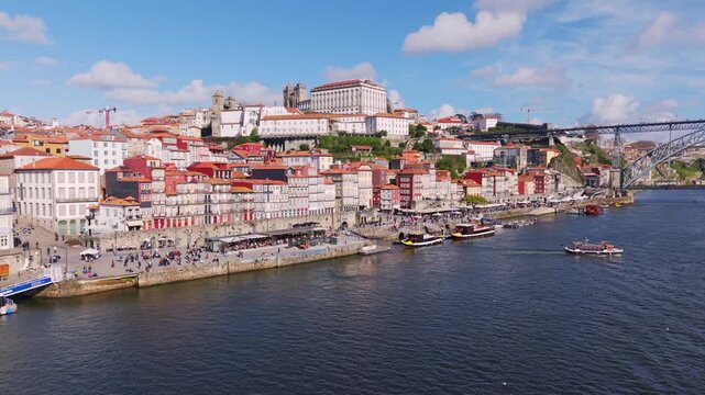 Porto old town on Douro River, medieval houses and lively promenade, Drone shot