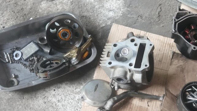 motorcycle engine being disassembled into the magnet block and cylinder sections