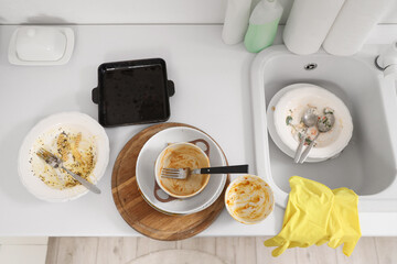 Dirty dishes on counter near sink in kitchen, top view