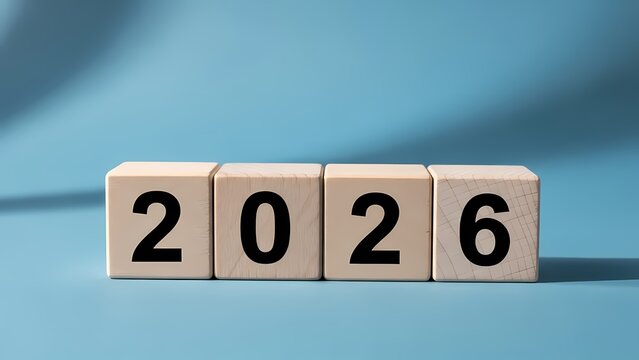 Wooden blocks displaying the year 2026 on a blue background