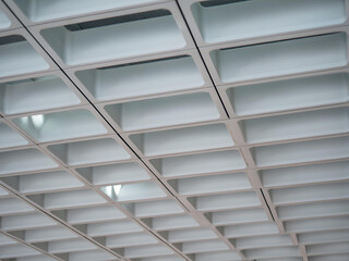 Modern White Ceiling with Geometric Grid Pattern and Minimalist Light Fixtures in Office Interior Design