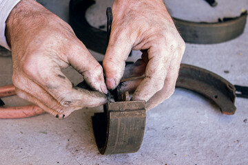 Mechanic repairing car brake pads close up