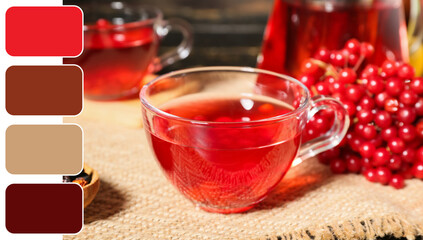 Glass cup of hot viburnum tea on wooden background