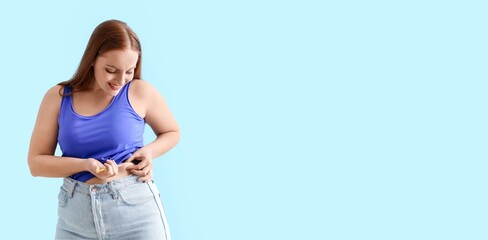 Woman with diabetes giving herself injection of insulin on light blue background with space for text