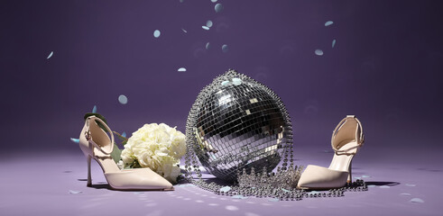 Stylish high heels with disco ball, tiara and flowers on violet background © Pixel-Shot