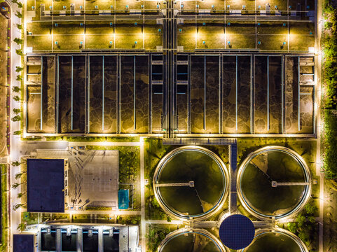 Aerial Night View of Illuminated Wastewater Treatment Plant