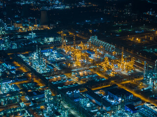 Aerial Night View of Glowing Industrial Complex with Pipelines