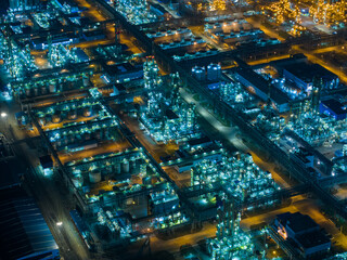 Aerial Night View of Glowing Industrial Complex with Pipelines