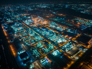 Aerial Night View of Glowing Industrial Complex with Pipelines