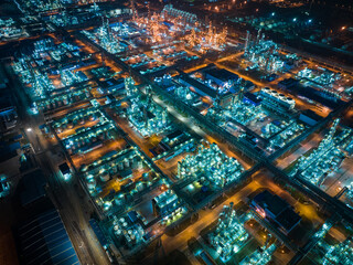 Aerial Night View of Glowing Industrial Complex with Pipelines