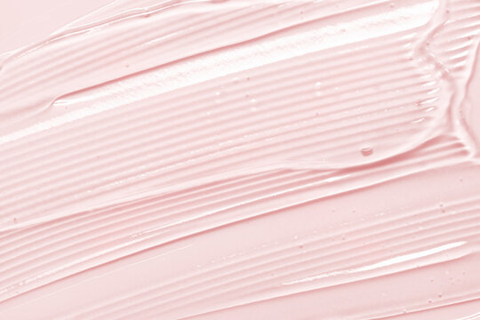 Gel texture. Pink liquid cosmetic background. Skincare serum, beauty cream with bubbles closeup