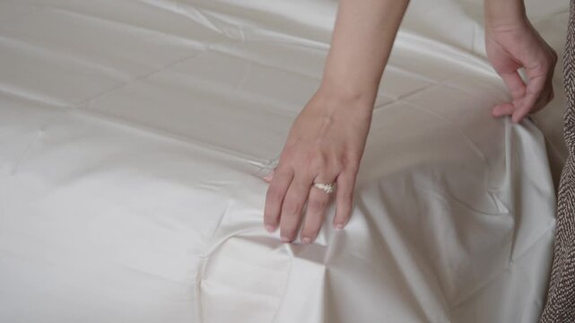 Changing bed sheets and making a bed in a bedroom