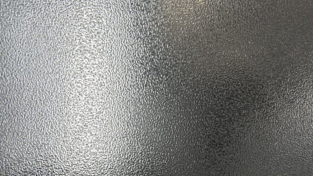 Textured Glass Surface with Light and Shadow Play.
