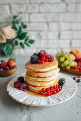 Pancakes topped with fresh berries served with coffee