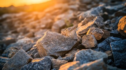 Rough unworked stone fragments piled outdoors catching warm golden sunlight
