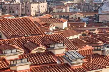 Roofs Prague Cityscape Red Tiles: Aerial view of historical terracotta rooftops in Prague, Czech Republic, showcasing traditional architecture.
