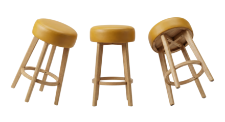 three wooden stools with round yellow seats arranged on a seamless black background isolated