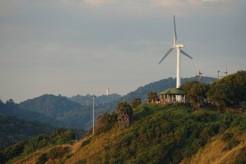 Wind turbines generating electricity, with the sky as a backdrop.