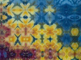 Hand-Died Fabric with Repeating Abstract Floral Motif in Yellows and Pinks with a Blue Background