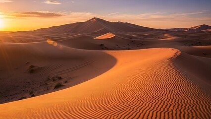 Golden desert sand dunes at sunset.