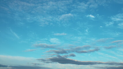The Beautiful Blue Sky adorned with Clouds at Dusk radiates tranquility and peace