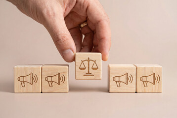 Concept of honest marketing ethics building consumer trust with hand placing wooden block with scale icon among megaphones
