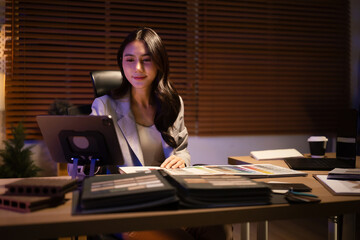 Professional interior designer working with sample books and a tablet in a modern studio, focused on creative design ideas