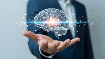 Human hand holding glowing digital wireframe brain with 'AI' text, symbolizing artificial intelligence technology concept