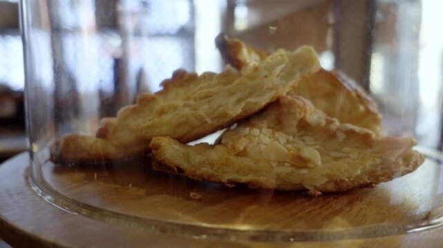Freshly baked almond tuile cookies stored in cafe jar