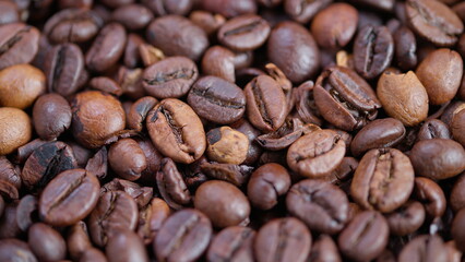 Fototapeta premium Detailed view of roasted beans, Texture and sheen of coffee beans showcased, Studio shot capturing diverse coffee beans with emphasis on texture and warm lighting effects