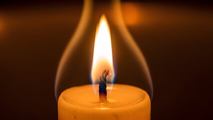 Close-up of a burning candle with a bright flame, creating a warm and inviting ambiance