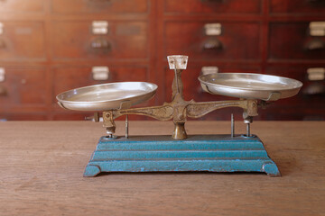 old scales, weight balance with Thai Indian Chinese herbs drawer cabinet shop background