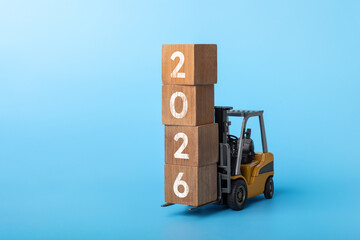 2026 happy new year background. new year industrial concept forklift carrying box written 2026 © Marsyago