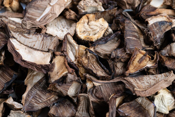 Bulk dried mushrooms arranged for commercial presentation and sale, Substantial quantity of sliced dried mushrooms prepared for retail and wholesale distribution